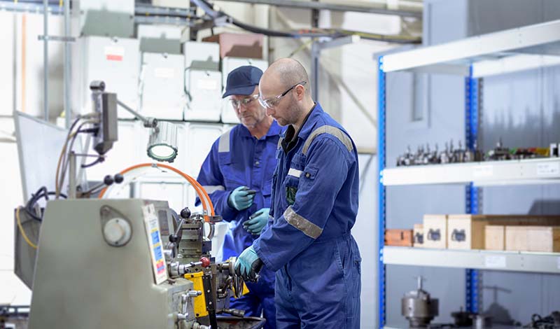 PEC employees performing industrial maintenance