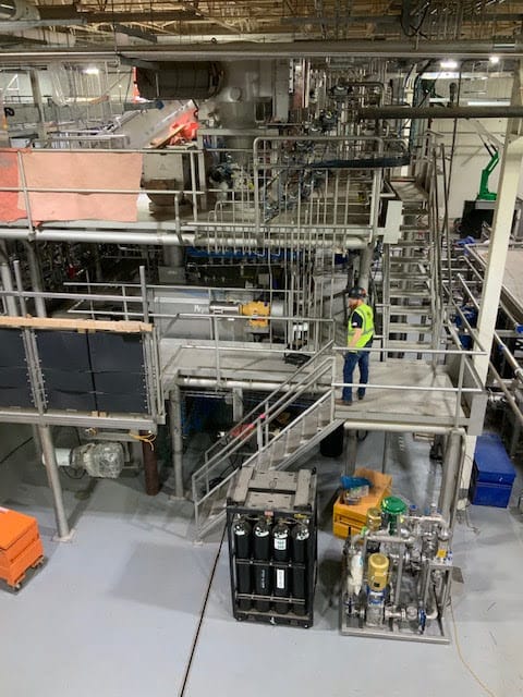 PEC employee inspecting large scale industrial equipment | Mechanical Contractors McDonough, GA