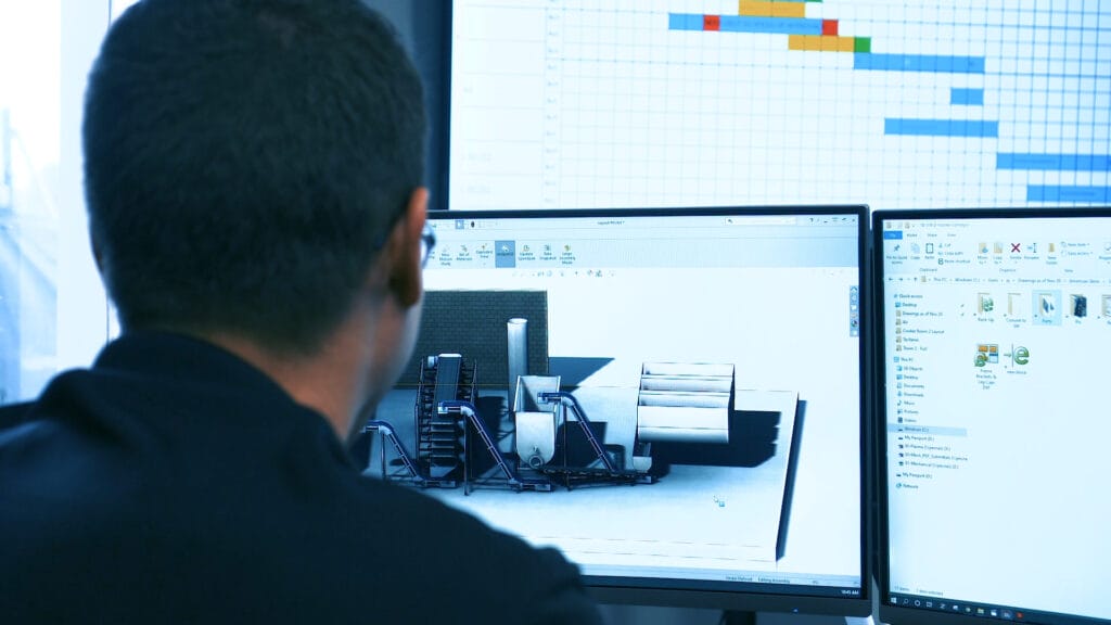 PEC specialist working at computer screen on process design